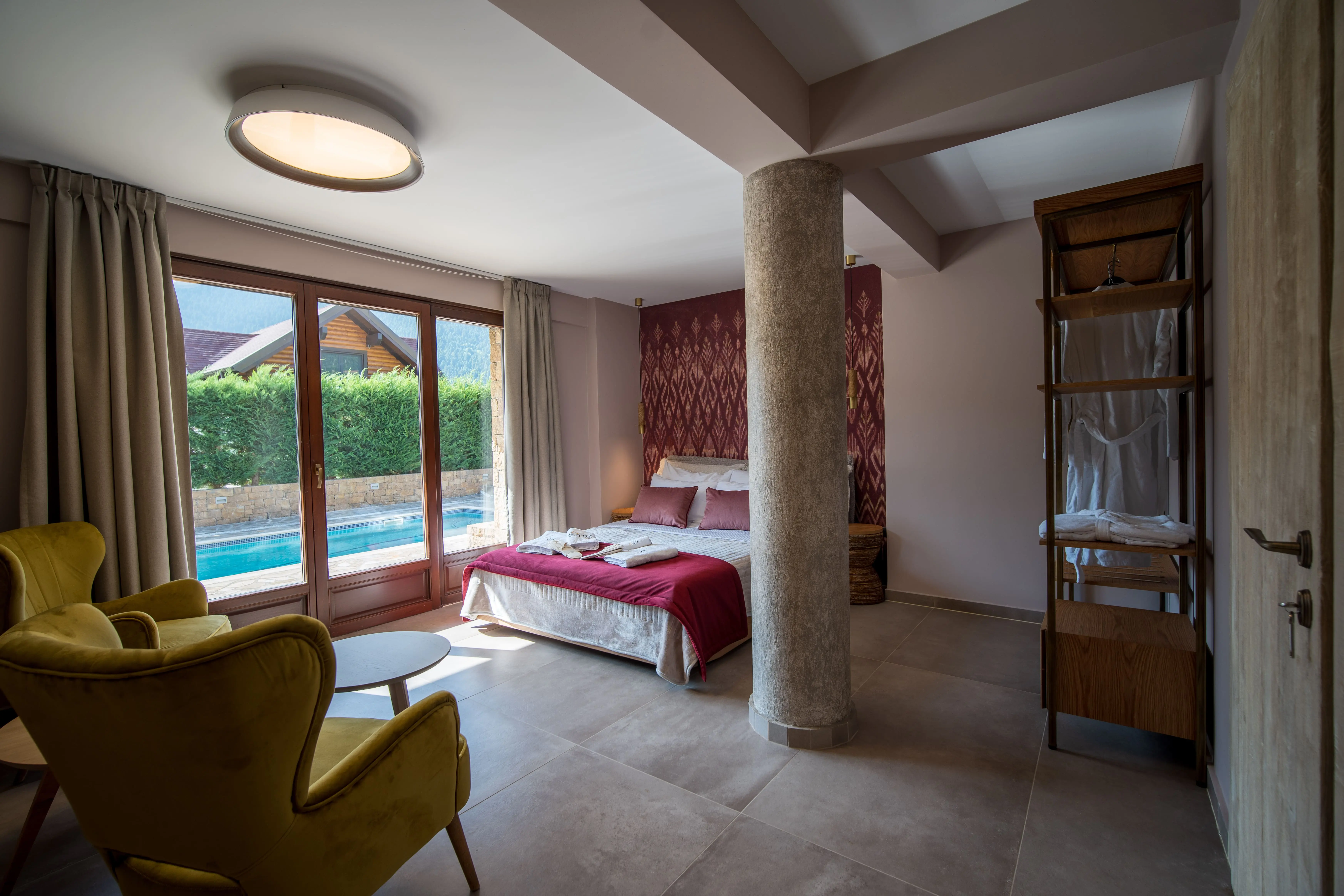 Design suite bedroom in Evritos Villas with kingsize bed and direct access to the outdoor pool